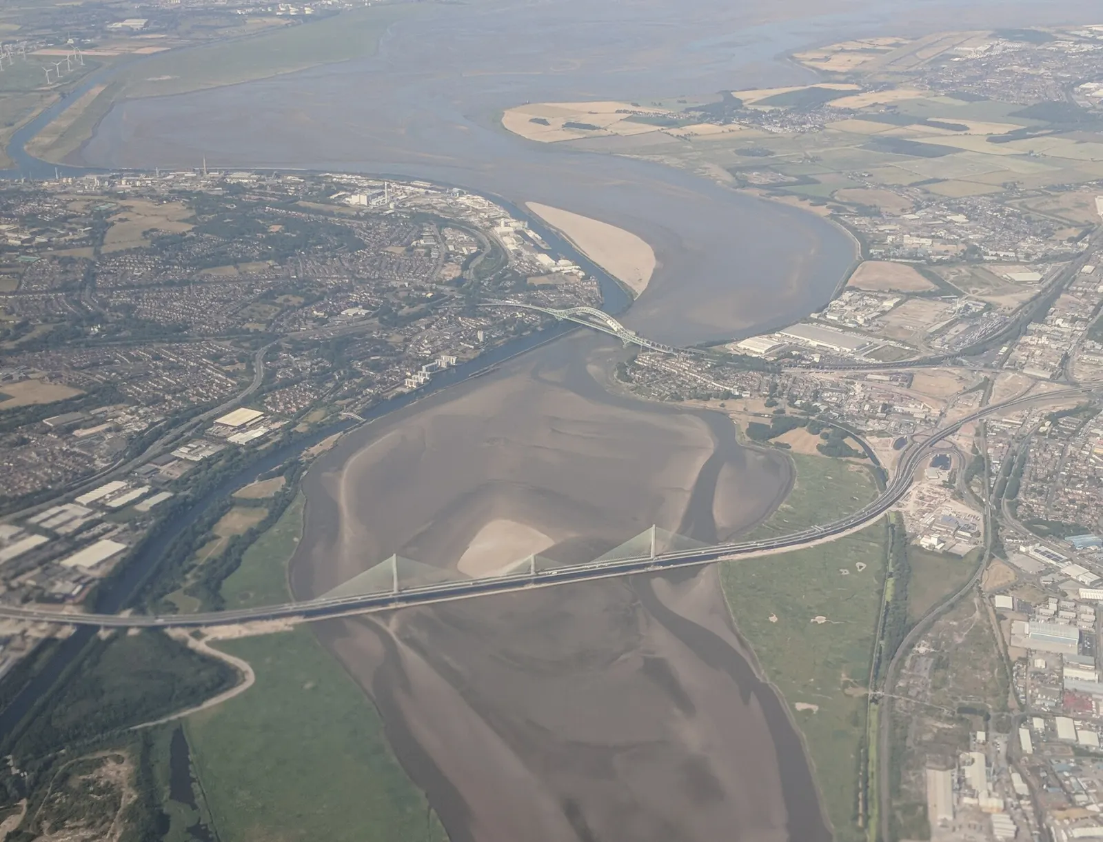 Aerial view of Runcorn and the River Mersey, with the Silver Jubilee Bridge and the Mersey Gateway Bridge crossing the river